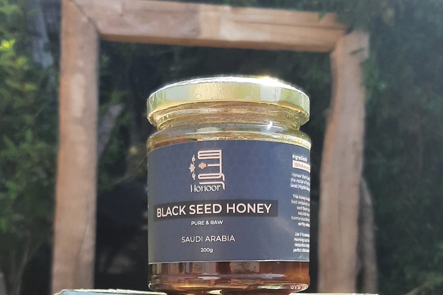Jar of Black seed honey capturing the sun