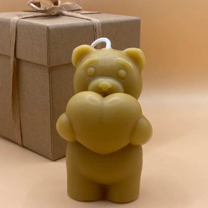 beeswax bear holding heart