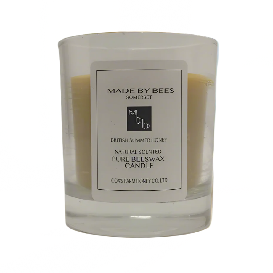 luxury candle in foreground with made by bees label