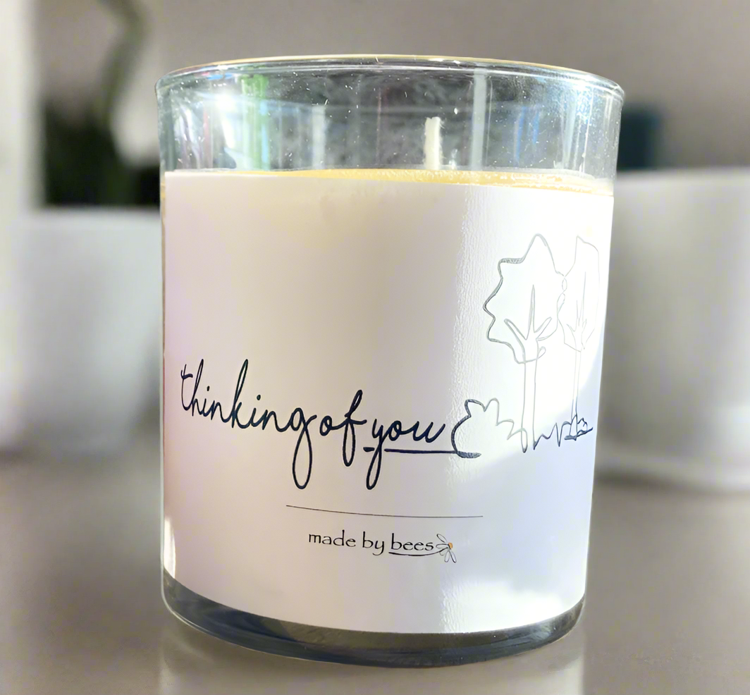 votive candle with label that reads thinking of you
