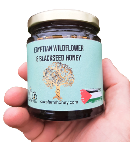 hand holding jar of Egyptian wildflower & Black seed honey