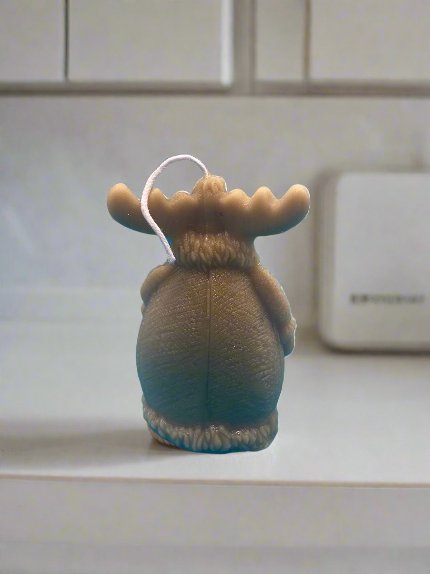 back of moose in a coat candle showing the detailing of the coat