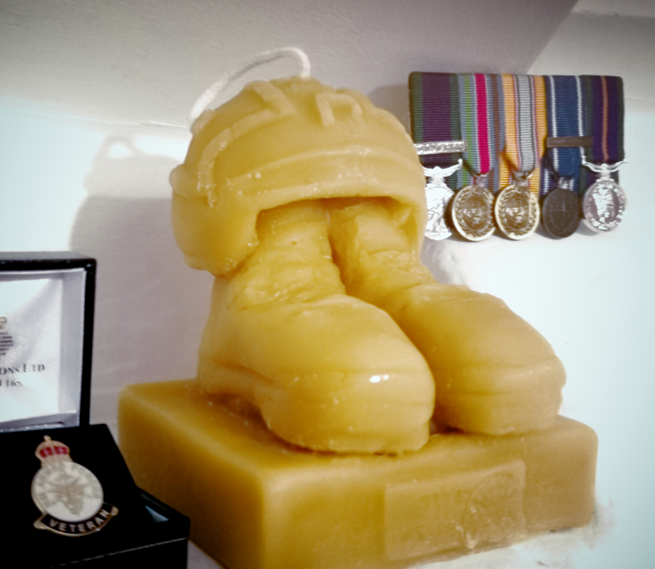 veterans candle with medals in background