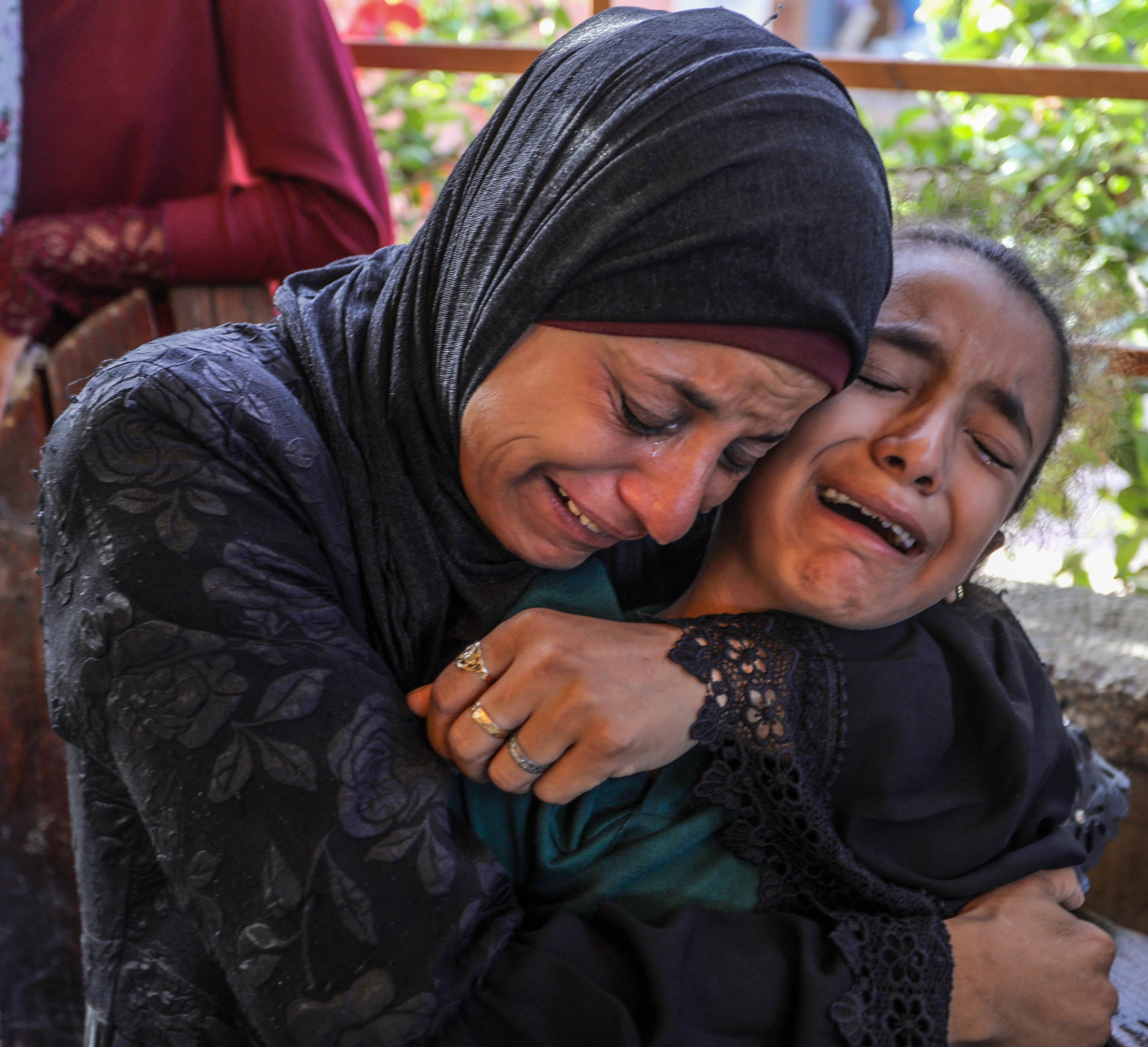 Palestinian mother comforts daughter