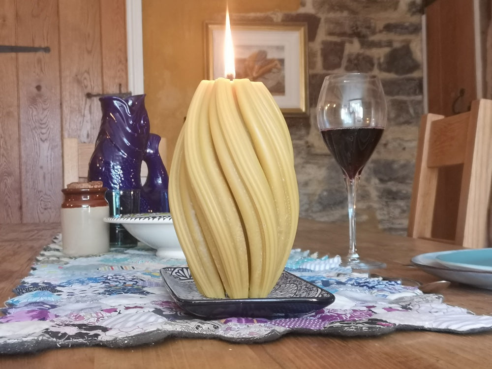 spiral pillar candle centrepiece on dinner table