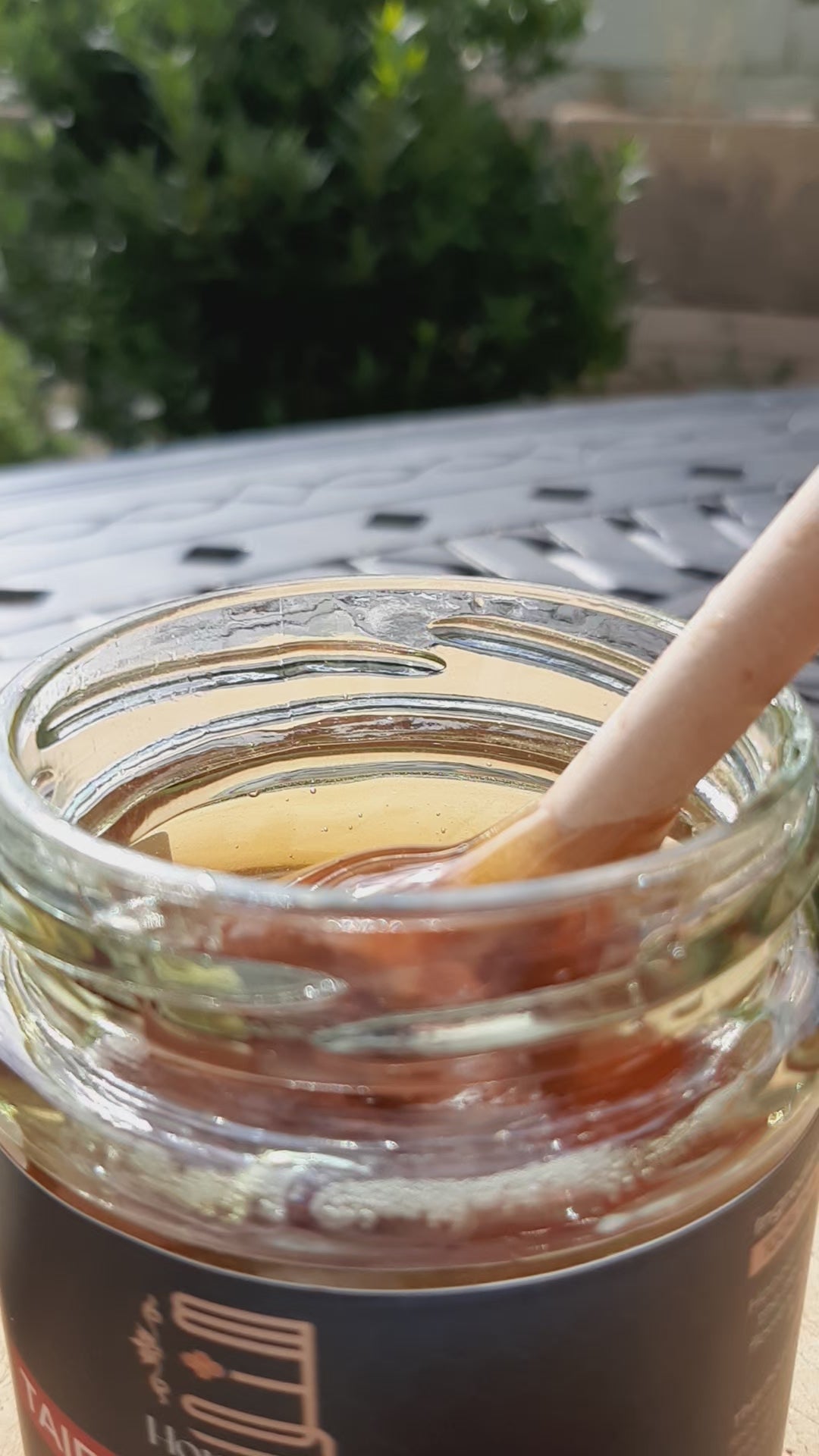 Taif rose honey drizzling in sunlight