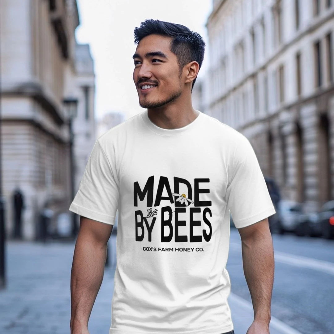 man wearing made by bees white tee